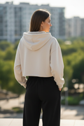 Beige cropped hoodie - back view outdoor showing relaxed fit