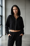 Black cropped hoodie - front view indoor showing navel length and fleece lining