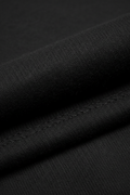 Black sweatpants fabric texture - close-up macro detail of soft cotton fleece