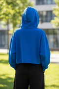 Blue cropped hoodie - back view outdoor showing oversized fit