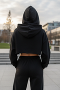 Black cropped hoodie - back view outdoor showing oversized relaxed fit