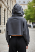 Dark gray cropped hoodie - back view outdoor showing oversized silhouette