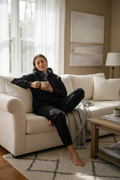 Black sweatpants - cozy home lifestyle, woman relaxing on sofa with coffee