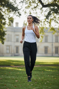 Black jogger sweatpants - woman jogging in UK park, active lifestyle photography