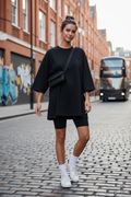 Black oversized t-shirt - woman wearing streetwear style with bike shorts