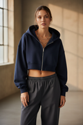 Navy blue cropped hoodie - front view indoor with silver zipper detail